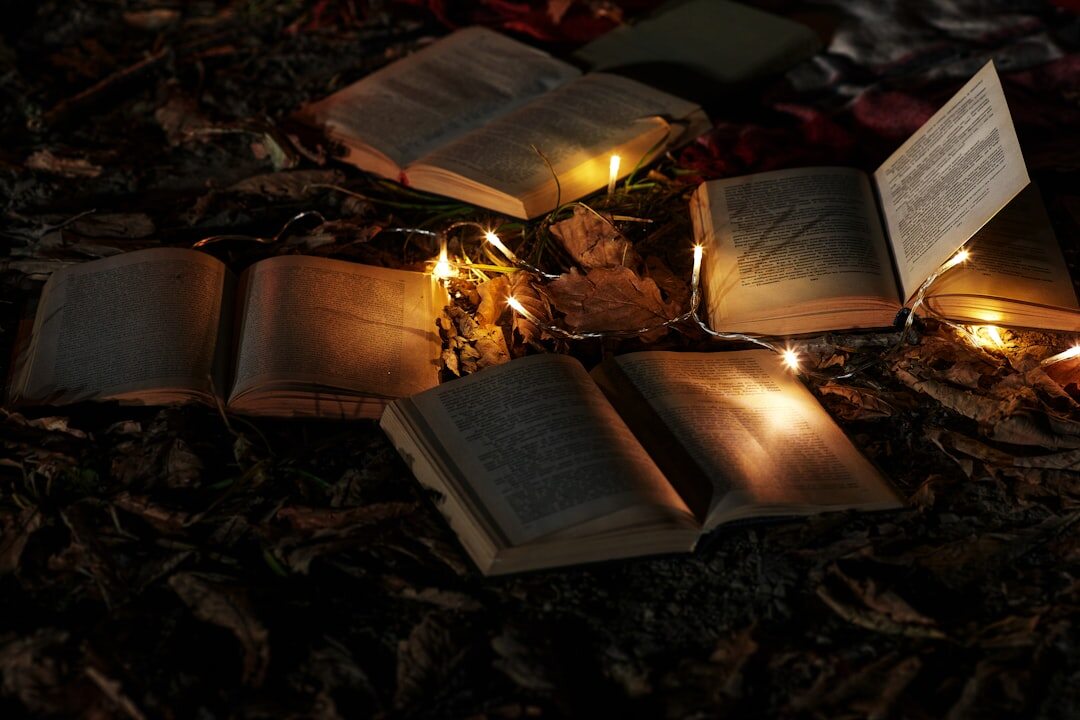 pile of books with flashlight